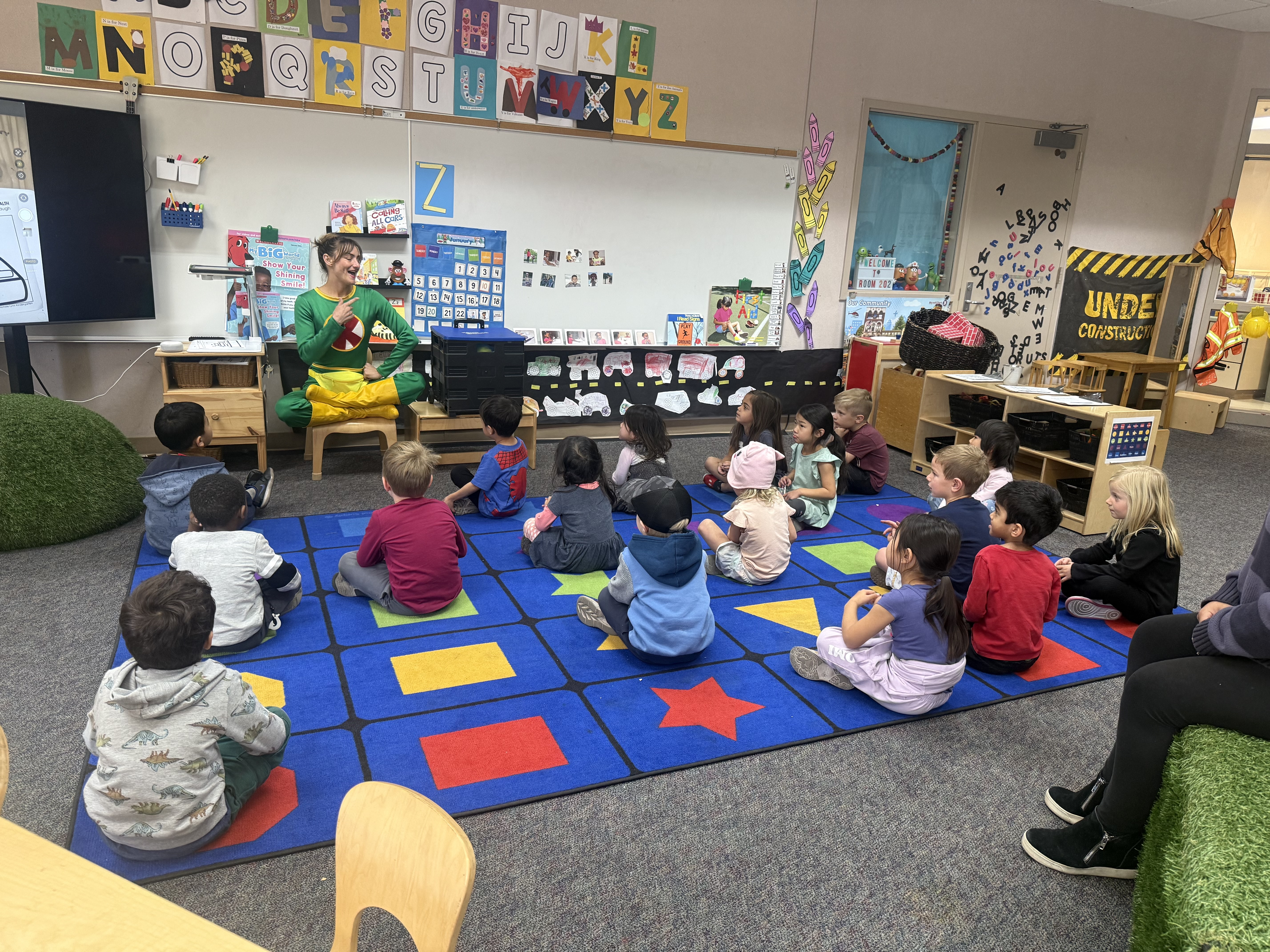 2 children doing art with teacher